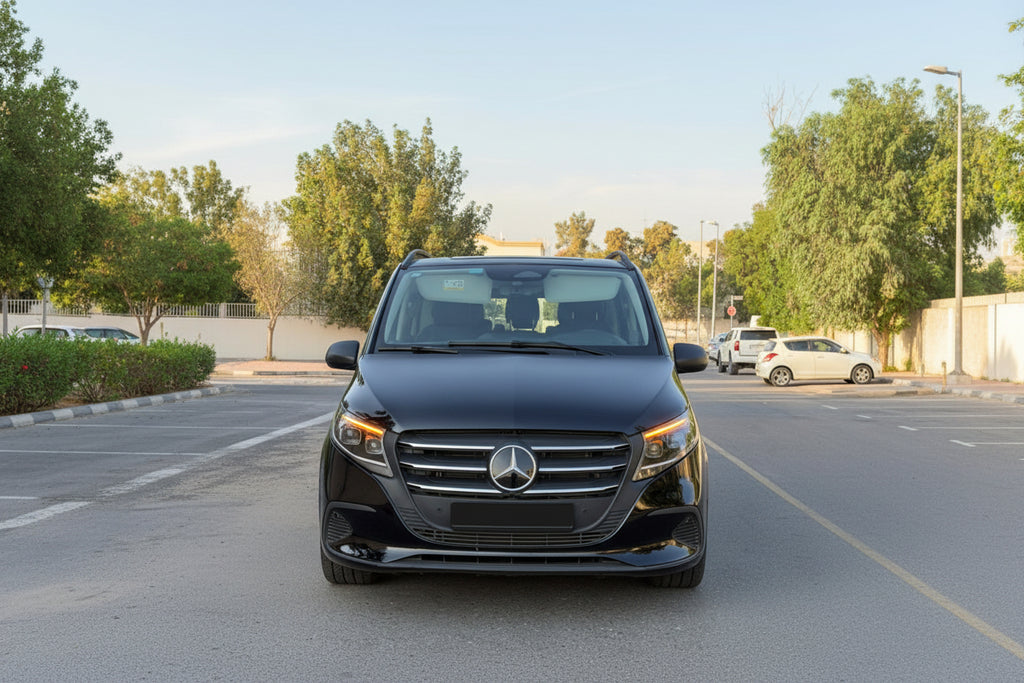 A black Mercedes-Benz Vito minivan parked outdoors on a paved lot, facing forward. The front grille features the prominent Mercedes-Benz logo, and a license plate is mounted below it.